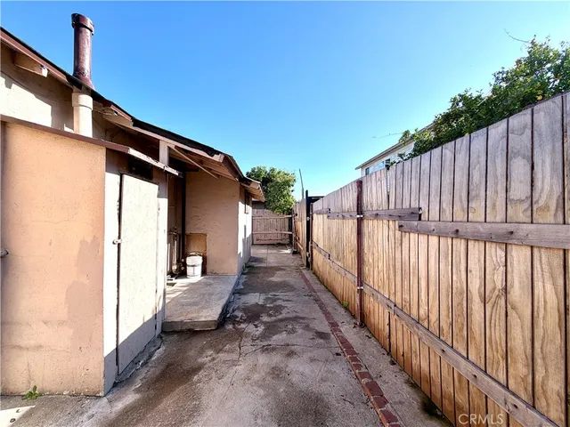 a view of a house with wooden fence