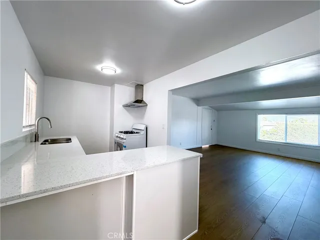 a room with a bed and a wooden floor