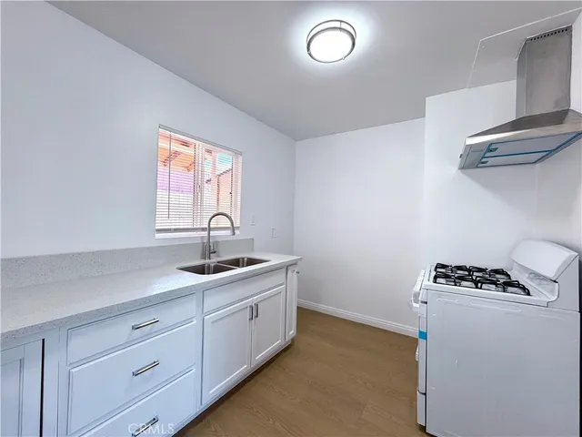 a kitchen with cabinets and window