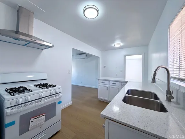 a kitchen with white cabinets and appliances