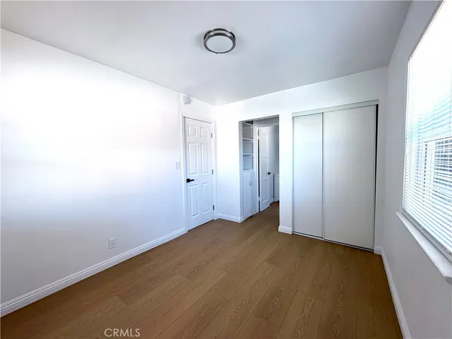 an empty room with windows and closet