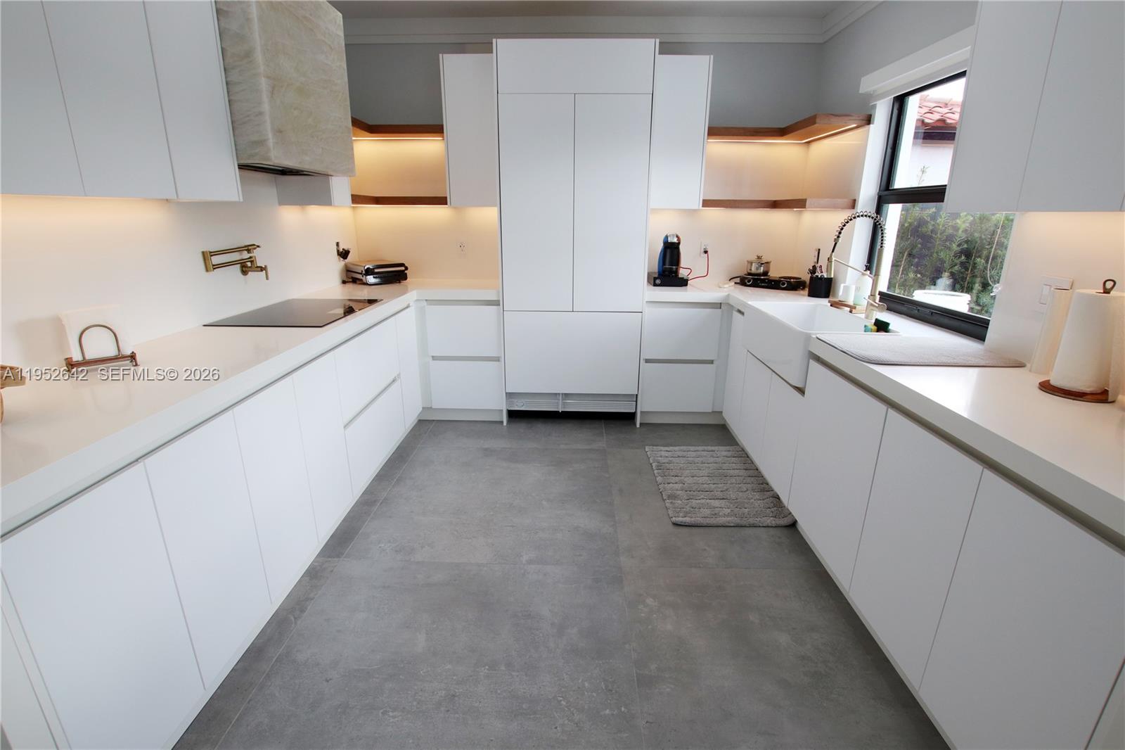 14218 Southwest 291st Street Homestead, FL 33033 - Photo 13 of 36 a large white kitchen with a sink a stove and a window