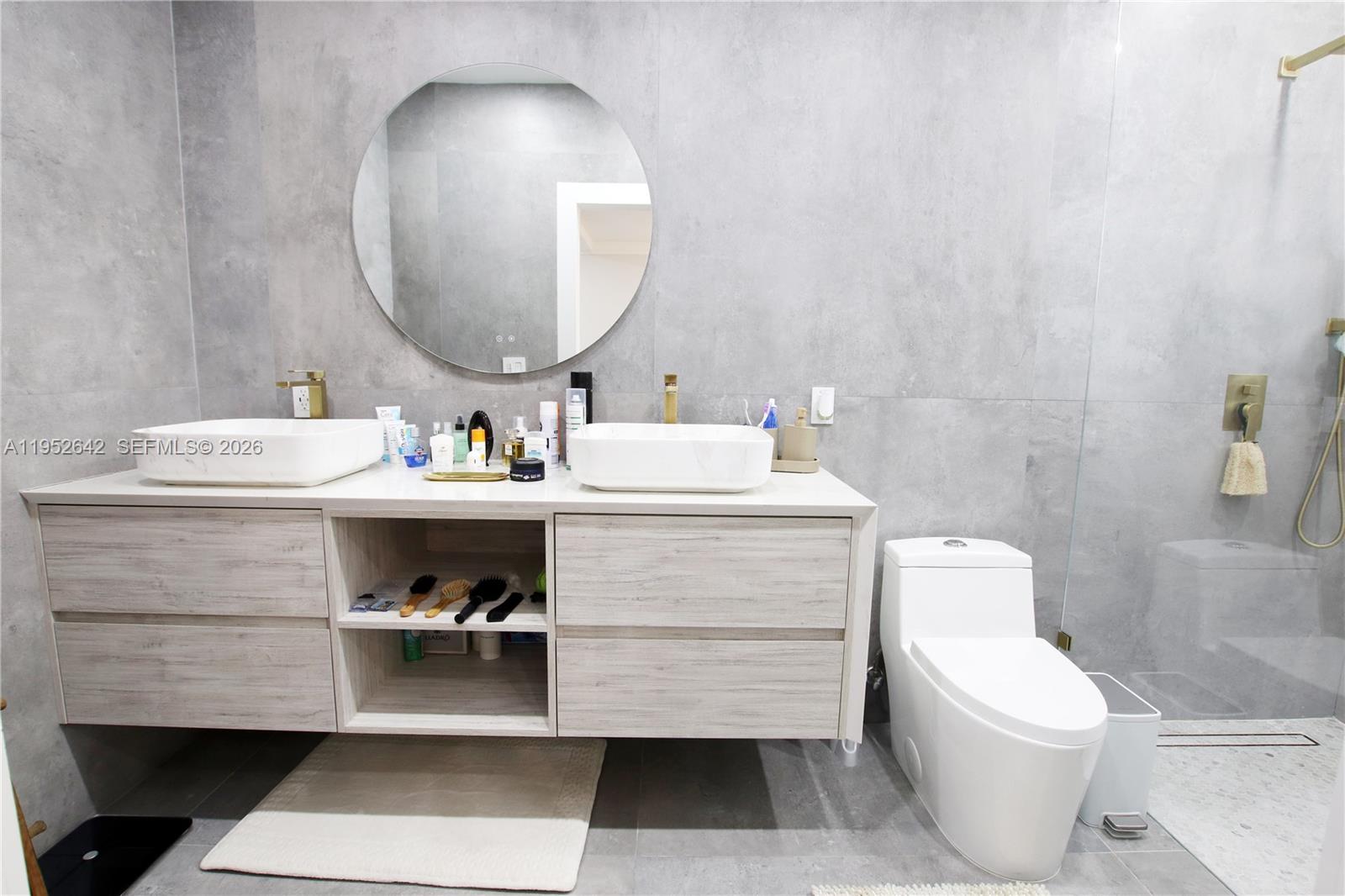 14218 Southwest 291st Street Homestead, FL 33033 - Photo 26 of 36 a bathroom with a sink mirror and toilet
