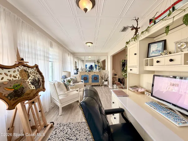 a spacious bedroom with a bed and a chandelier