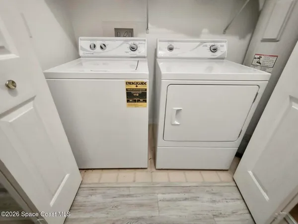 an aerial view of a house with a yard and ocean view