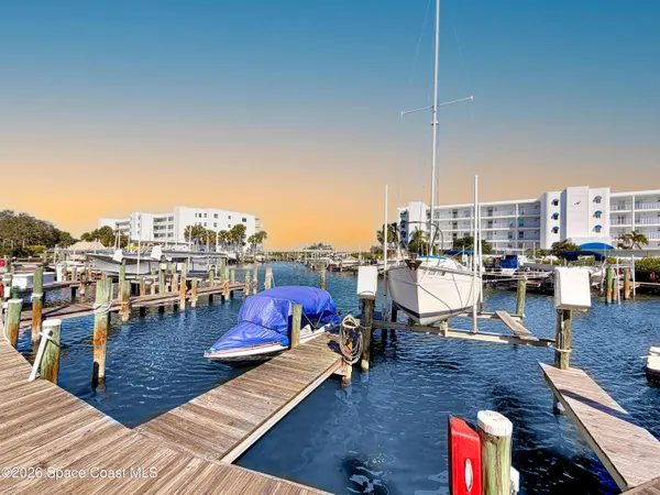 an aerial view of lake and residential houses with outdoor space