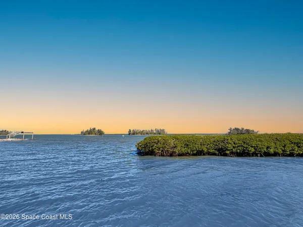 an aerial view of a house with a ocean view