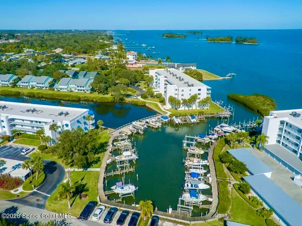 an aerial view of a houses with a yard