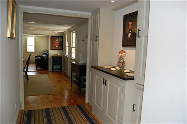 465 Stage Harbor Road Chatham, MA 02633 - Photo 17 of 17 a hallway with a sink and cabinets