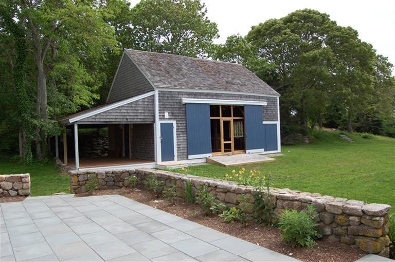 465 Stage Harbor Road Chatham, MA 02633 - Photo 5 of 17 a front view of a house with a yard and trees