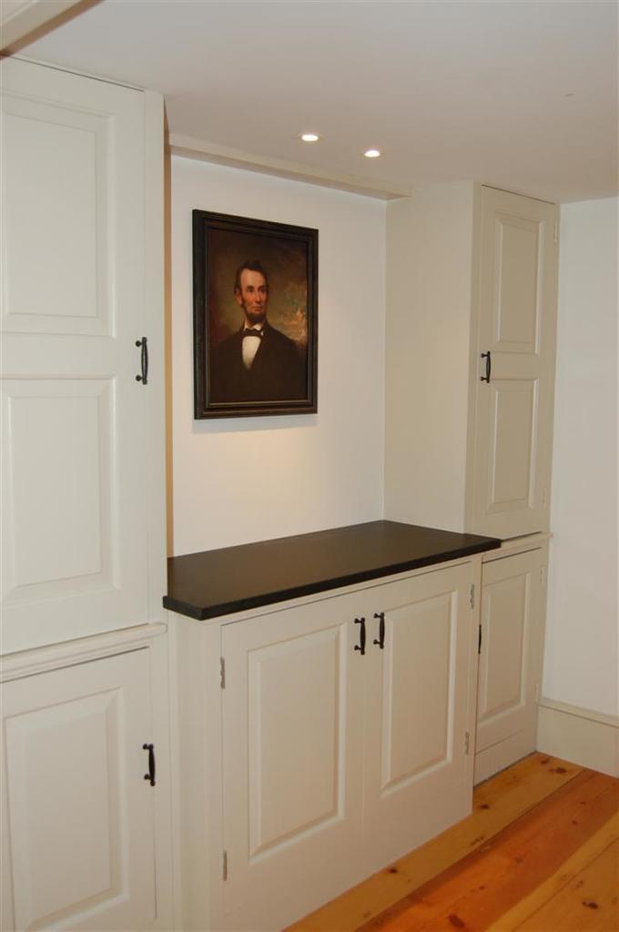 465 Stage Harbor Road Chatham, MA 02633 - Photo 9 of 17 a hallway with white cabinets and wooden floor