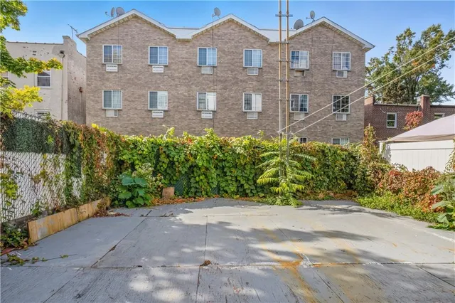 a front view of a house with a yard and a garden