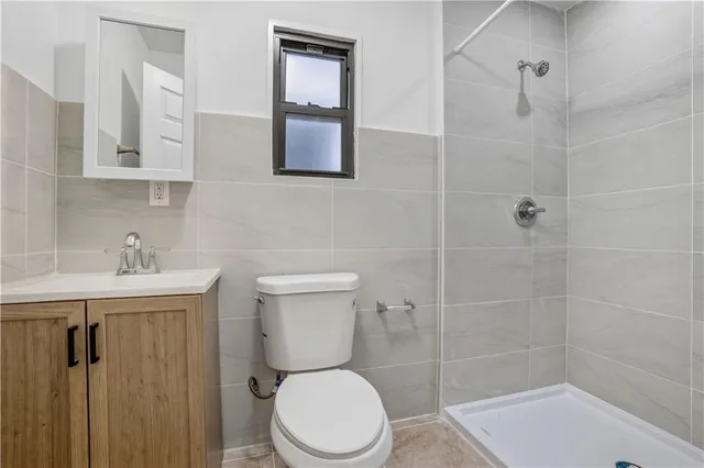 a white toilet sitting next to a bathroom sink