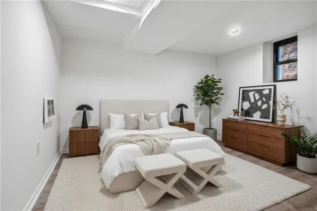 a bedroom with a bed table and chair