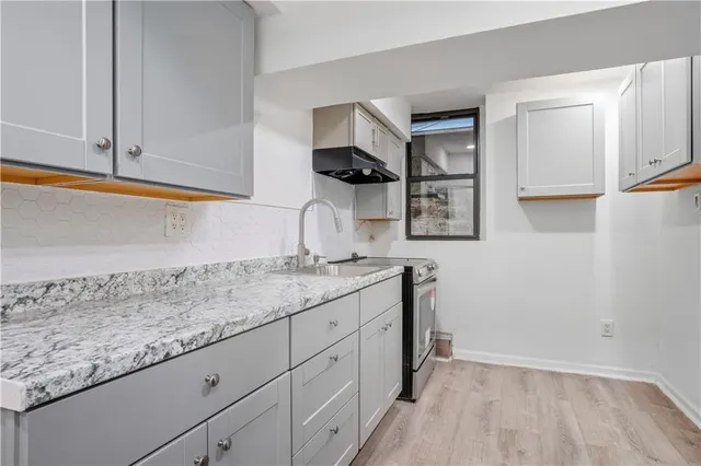a kitchen with a sink and cabinets