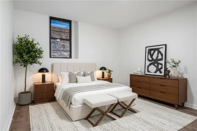 a bedroom with a bed and a potted plant