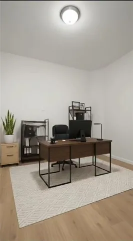 a living room with furniture and painting on the wall