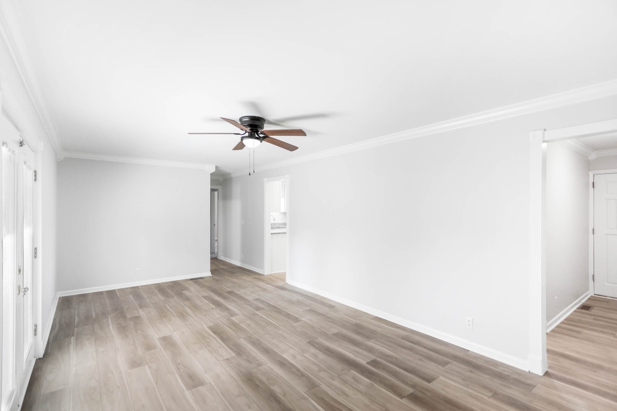 211 General Forrest Drive Springfield, TN 37172 - Photo 3 of 23 an empty room with wooden floor fan and windows