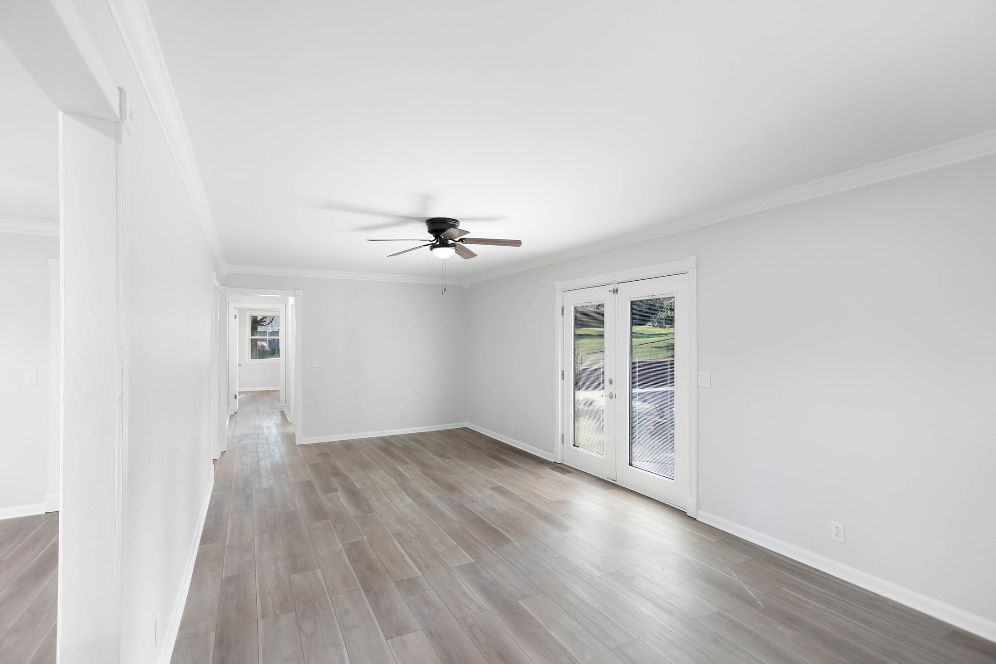 211 General Forrest Drive Springfield, TN 37172 - Photo 4 of 23 an empty room with wooden floor chandelier fan and windows