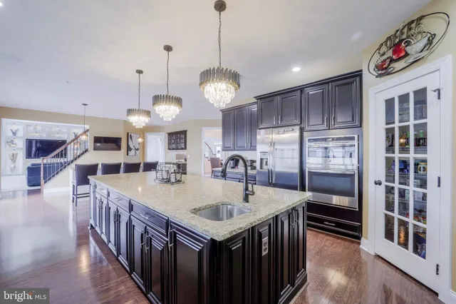 a bathroom with a sink a light fixture and a mirror