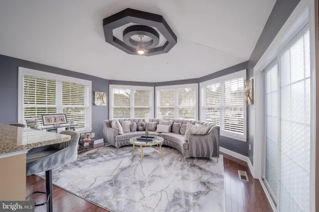 a bathroom with a granite countertop toilet sink and mirror