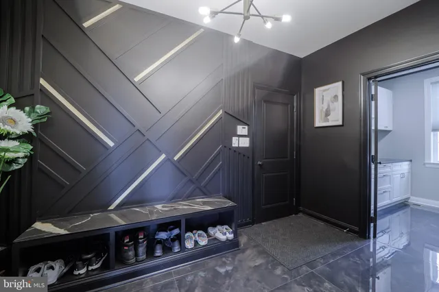 a spacious bedroom with a bed a dresser and mirror