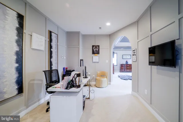 a living room with stainless steel appliances kitchen island granite countertop furniture and a flat screen tv