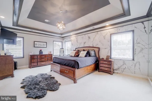 a bathroom with a granite countertop sink a toilet a mirror and a tub