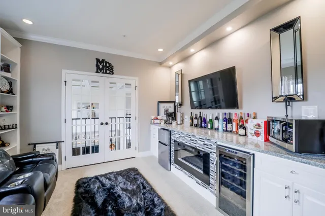 a spacious bedroom with a bed and a chandelier