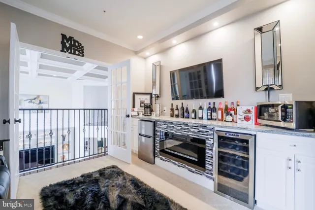 a spacious bedroom with a large bed and a flat tv screen