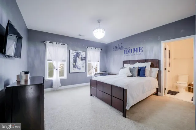 a bathroom with a granite countertop sink a toilet and a mirror