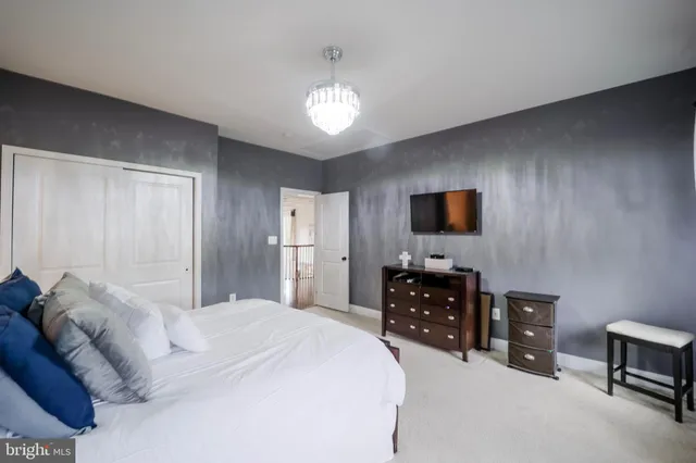 a living room with furniture a table and kitchen view