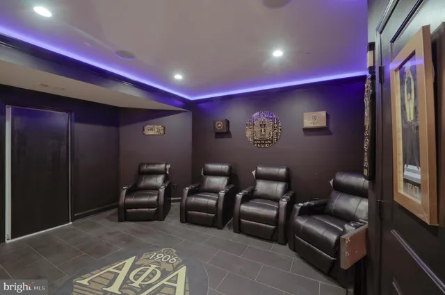 a living room with furniture a fireplace a flat screen tv and a large window