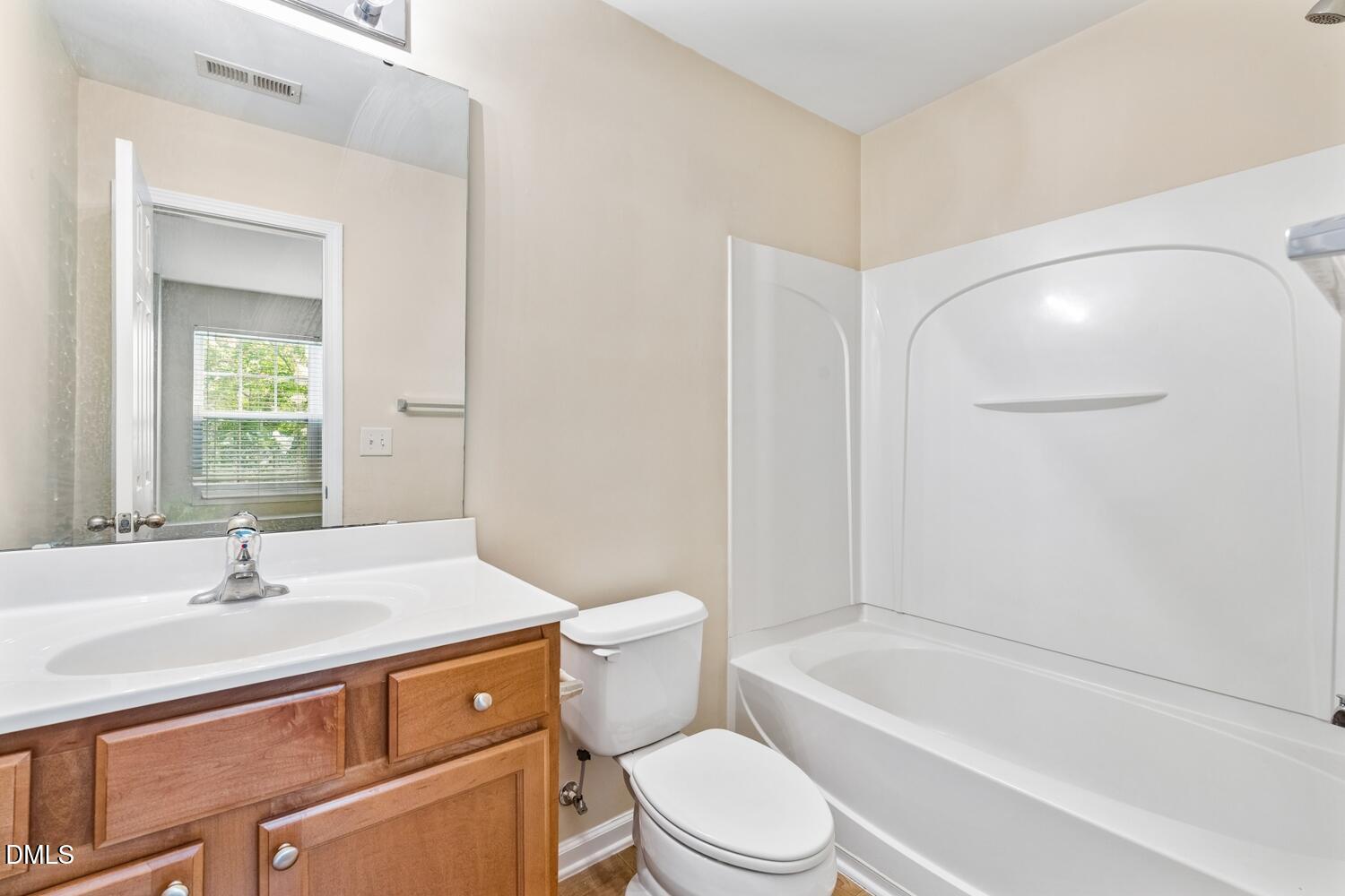 3635 Bison Hill Lane Raleigh, NC 27604 - Photo 14 of 18 a bathroom with a sink a toilet and shower