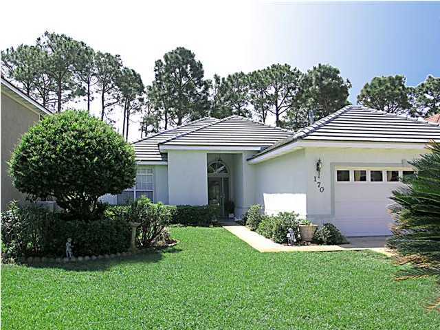 170 Indigo Loop Miramar Beach, FL 32550 - Photo 1 of 15 a front view of a house with a yard and potted plants