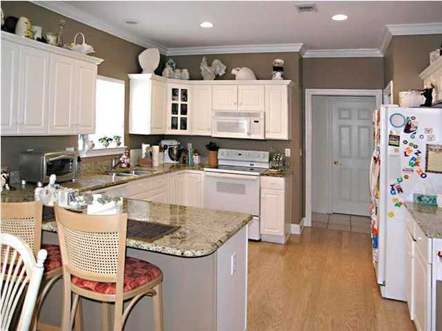 170 Indigo Loop Miramar Beach, FL 32550 - Photo 7 of 15 a kitchen with stainless steel appliances granite countertop a stove and a refrigerator