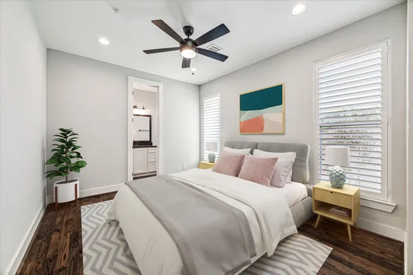 a bedroom with a large bed and a chandelier