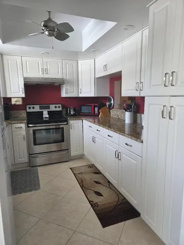 a kitchen with stainless steel appliances granite countertop a sink and cabinets