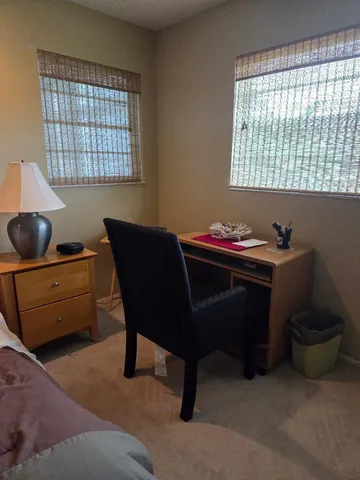 a dining room with a desk and a window