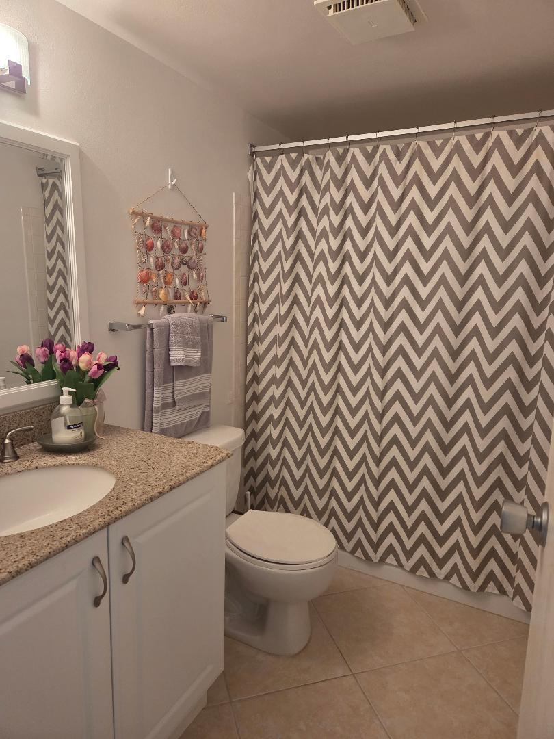 2950 Southeast Ocean Boulevard, Unit 1317 Stuart, FL 34996 - Photo 14 of 19 a bathroom with a granite countertop sink and a toilet