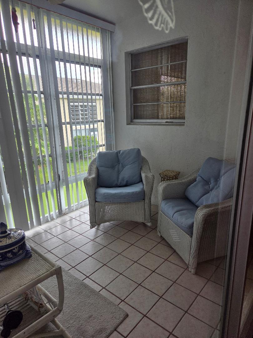 2950 Southeast Ocean Boulevard, Unit 1317 Stuart, FL 34996 - Photo 17 of 19 a living room with furniture and a floor to ceiling window