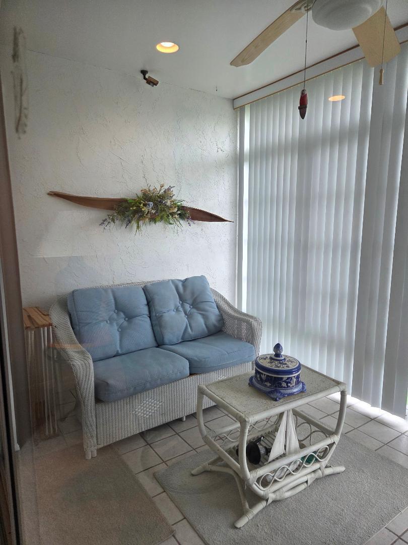2950 Southeast Ocean Boulevard, Unit 1317 Stuart, FL 34996 - Photo 18 of 19 a living room with furniture and a glass door