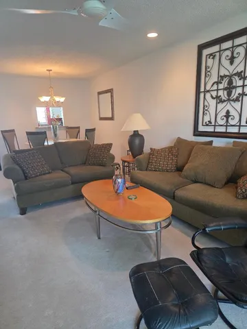 a living room with furniture and a lamp