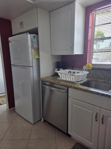 a white refrigerator freezer sitting inside of a kitchen