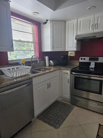 a kitchen with a sink stove and cabinets