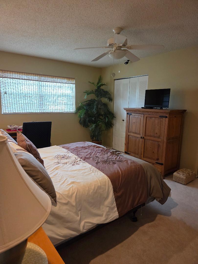 2950 Southeast Ocean Boulevard, Unit 1317 Stuart, FL 34996 - Photo 10 of 19 a bedroom with a bed and a window