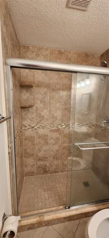 a bathroom with a glass shower door