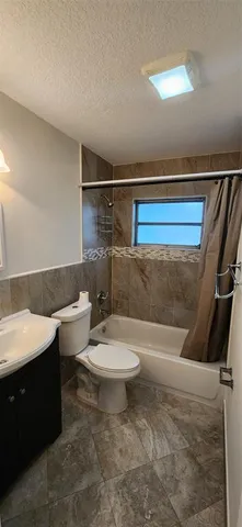 a bathroom with a toilet a sink and bathtub
