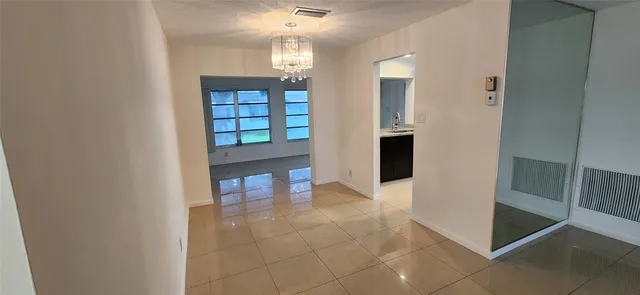 a view of room with windows and ceiling fan