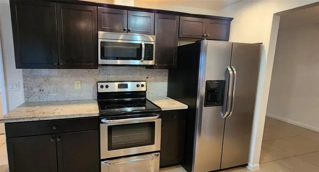a kitchen with a refrigerator stove and microwave